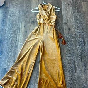 A golden velvet kids romper with a Golden rope belt